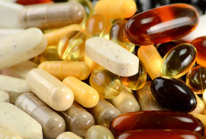 Close-up photo of various pills and capsules representing alternative medicines.
