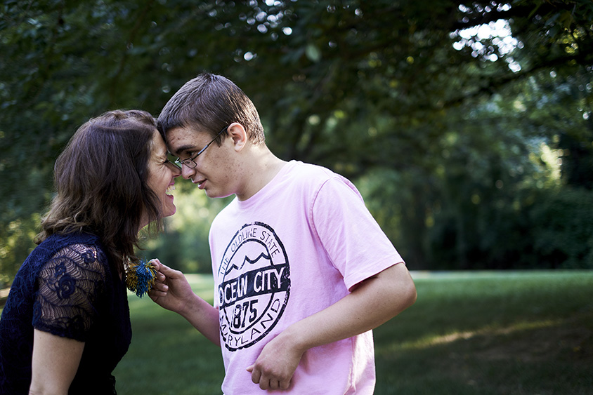 Kyle Becker, 17, shares an affectionate touch with his mother, Alison Becker, while walking at a park near home in Potomac, Md., on July 12, 2016. 