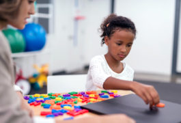 child playing with colorful puzzle