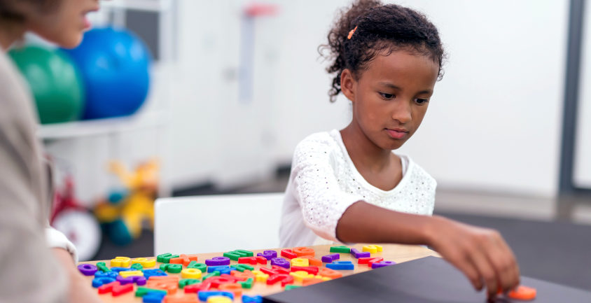 child playing with colorful puzzle