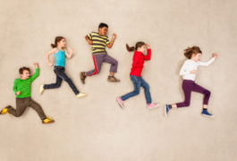birdseye view of five children in running formation