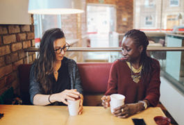 two women sitting in a coffee shop