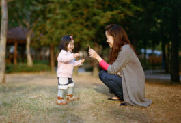 asian child and mother together in a park