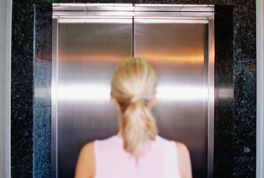 woman in front of closed elevator door