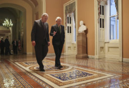 Republican Senate Majority Leader Mitch McConnell (right) and Democrat Senate Minority Leader Chuck Schumer (left) walk to the chamber after collaborating on an agreement in the Senate