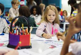 Child coloring in a classroom