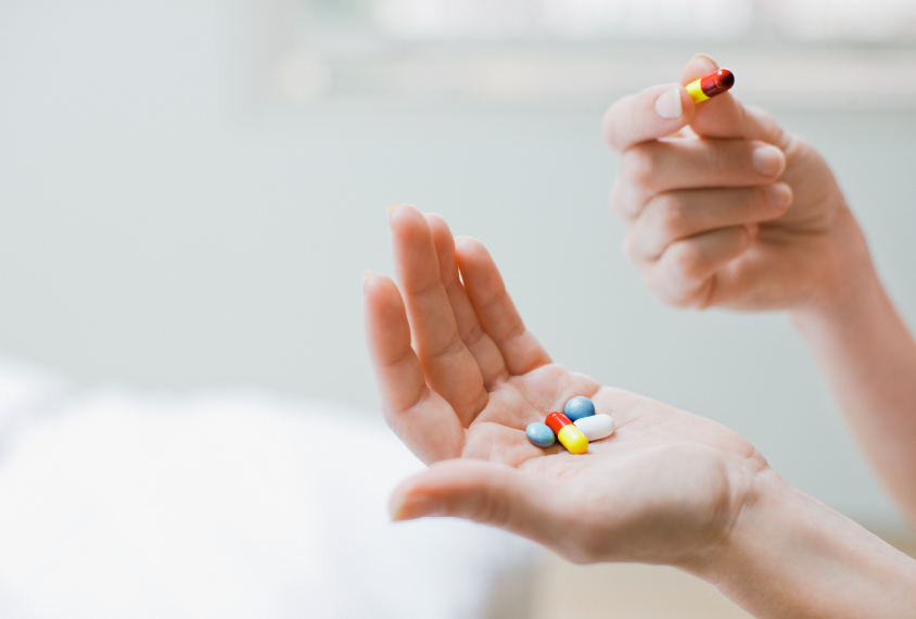 hands holding colorful pills