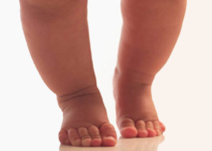 infant walking on tiptoes